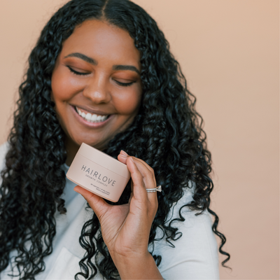 Woman holding HAIRLOVE Growth Complex
