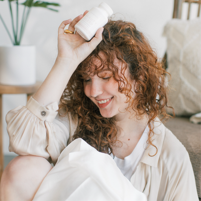 A Happy Woman Holding HAIRLOVE Beauty Sleep Capsules